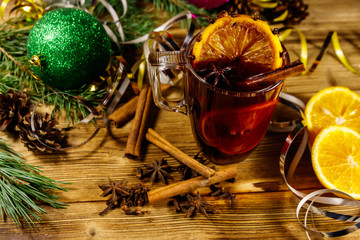 Christmas mulled wine with spices and Christmas decoration on wooden table