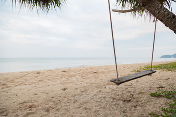 Wood swing at the beach and sand