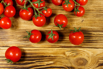 Fresh cherry tomatoes on a wooden table. Top view
