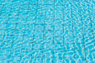 Water surface in blue swimming pool
