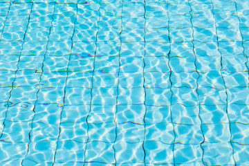 Water surface in blue swimming pool