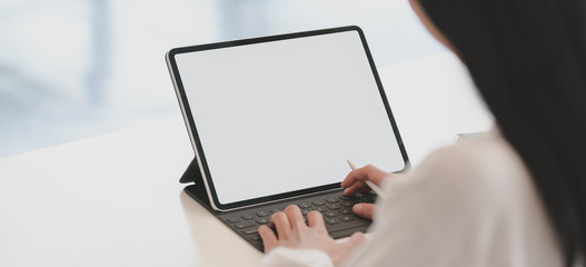 Cropped shot of young businesswoman working on her project while using tablet