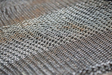 Medieval chain mail. weave iron rings linked together.