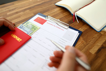 Male hand hold silver pen with passport