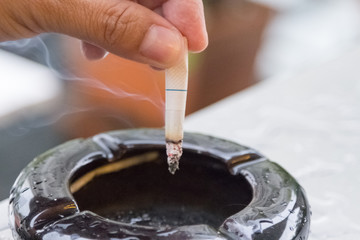Hand hold cigarettes going to quit smoking