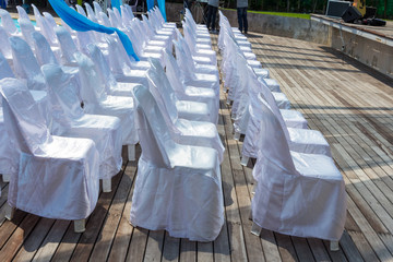 Row of chairs with white fabric covers