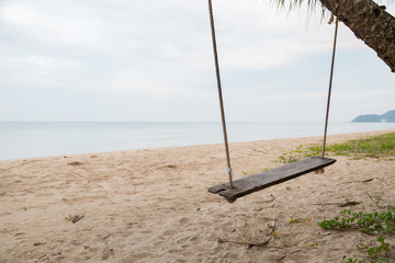 Fototapeta premium Wood swing at the beach and sand