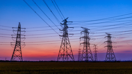 Fototapeta premium High voltage electricity tower sky sunset landscape,industrial background.