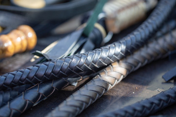 handles woven leather whips. texture of vintage instruments