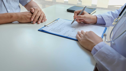 Female doctors who treat patients make an appointment to listen to the results after a physical examination and explain medical information and diagnose the disease. Medical concepts and good health