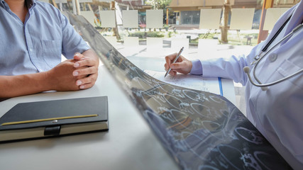 Female doctors, specialists in treatment, make an appointment to meet patients after x-ray and give advice, explain medical information and diagnose the disease. Concept of treatment and good health