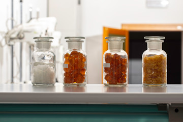 Glassware with plant extracts on table in laboratory