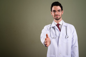 Portrait of young handsome man doctor with eyeglasses