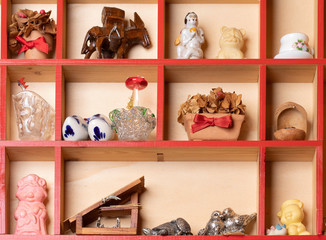 Various beautiful souvenirs on wooden shelf