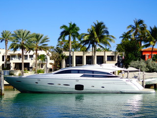 Life of Luxury: Ultra-modern silver yacht  in front of a millionaire's mansion in Miami, Florida...