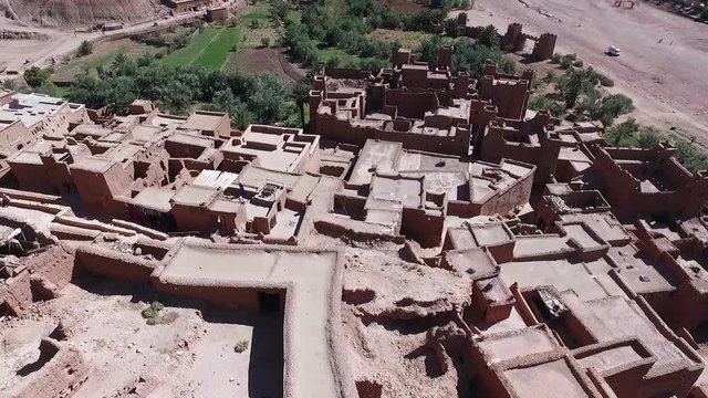 Flining ofer Ait-Ben-Haddou by drone at a sunny day.