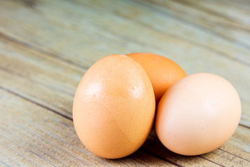 Three Eggs up close on a wooden background