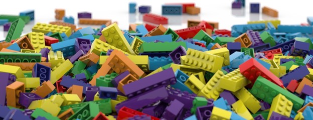 Colored toy bricks background. Rainbow colors. Random coloured plastic construction blocks. 3D illustration. 3D rendering. Isolated on white background