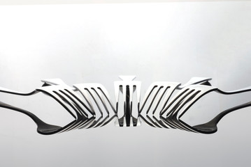 light and shadow of forks on white background