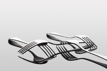light and shadow of forks on white background