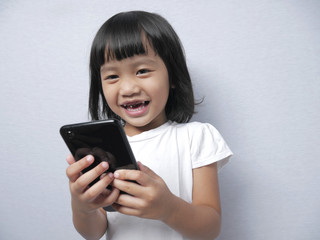 Fototapeta premium Little Girl With Smart Phone Gadget