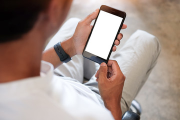 Mock up smartphone of hand holding black mobile phone with blank white screen.