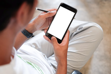 Mock up smartphone of hand holding black mobile phone with blank white screen.
