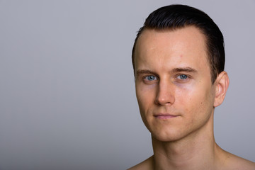 Fototapeta premium Studio shot of face of young handsome man shirtless