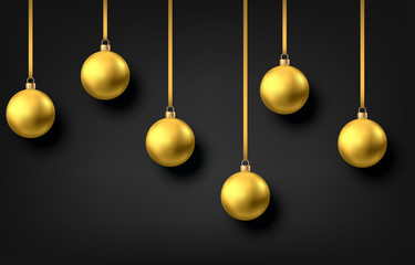 Golden  hanging Christmas balls isolated on black  background.