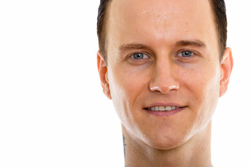 Studio shot of face of young handsome man shirtless