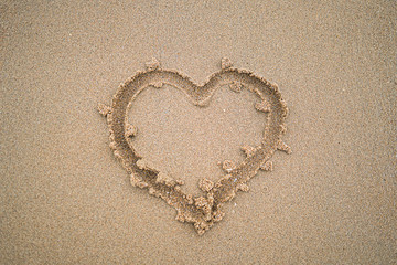 Heart drawn on beach sand