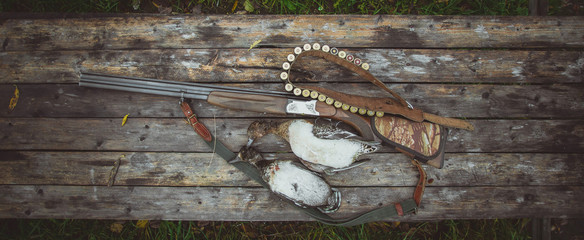 Russia, Kholmogory-October 17 2019 Double-barreled vertical shotgun, bandolier and two...