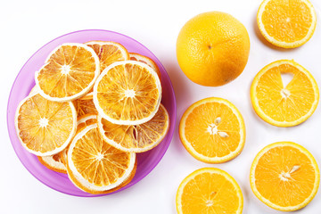 Ingredients for healthy fruit chips made of orange on white background. Vegetarian dietary food