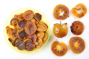 Ingredients for healthy fruit chips made of persimmon on white background. Vegetarian dietary food