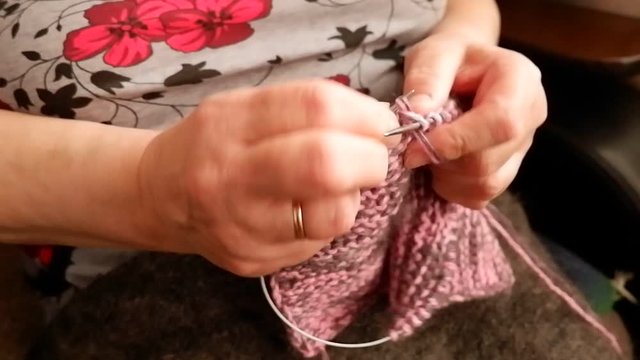 woman knitting wool socks