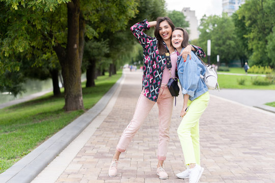 Two cheerful young girls walking in the Park