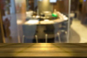 Fototapeta na wymiar Wooden table with blur restaurant background