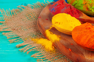 Vibrant Holi powder colors arranged in spoons