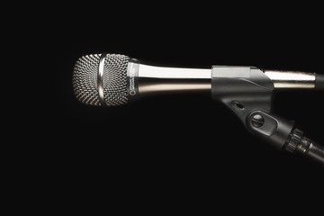 microphone on stand, black background