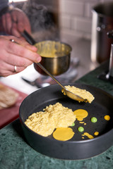 The chef serves the dish Pumpkin Risotto with with duck and parmesan cheese mousse. Seasonal autumnal recipe - risotto with organic pumpkins.