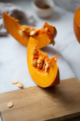 pumpkins with cinnamon sticks on marble backgrund