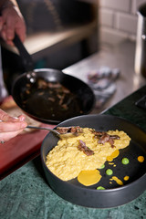 The chef serves the dish Pumpkin Risotto with with duck and parmesan cheese mousse. Seasonal autumnal recipe - risotto with organic pumpkins.