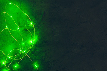 Obraz na płótnie Canvas Garland with green light elements in the dark close up