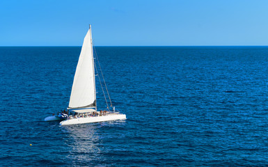 Sailboat in the sea with ongoing party aboard. Spain, Europe