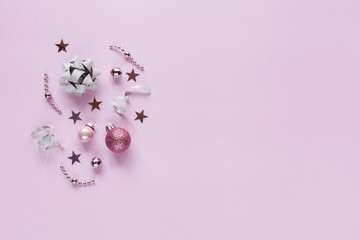 Pink christmas background with christmas balls and other decoration and accessories. Flat lay. Christmas mock-up