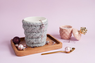 Cup in grey wool knitted cover. Hygge cozy home concept