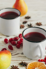 Autumn composition with hot mulled wine and spices on wooden background