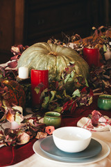 Fall thanksgiving decor with candle and pumpkins close up
