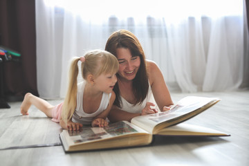 mom and daughter watching together photo album