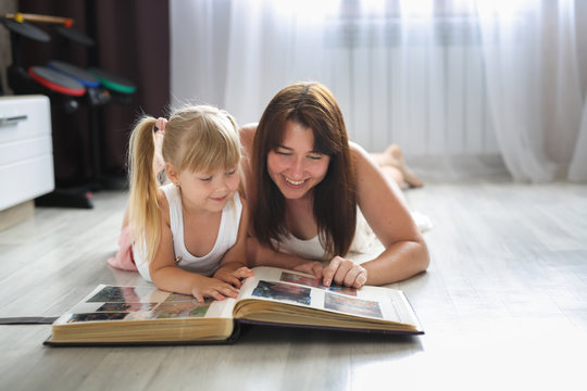 mom and daughter watching together photo album